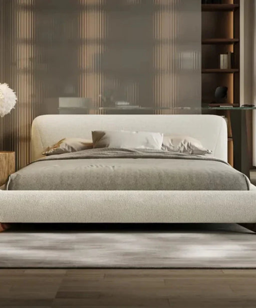 Oak Inside Modern bedroom with a beige upholstered bed, wooden side tables, and a glass desk.
